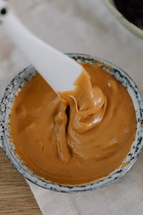 5 Best Peanut Butters for Dogs Bowl of Peanut Butter with a spatula