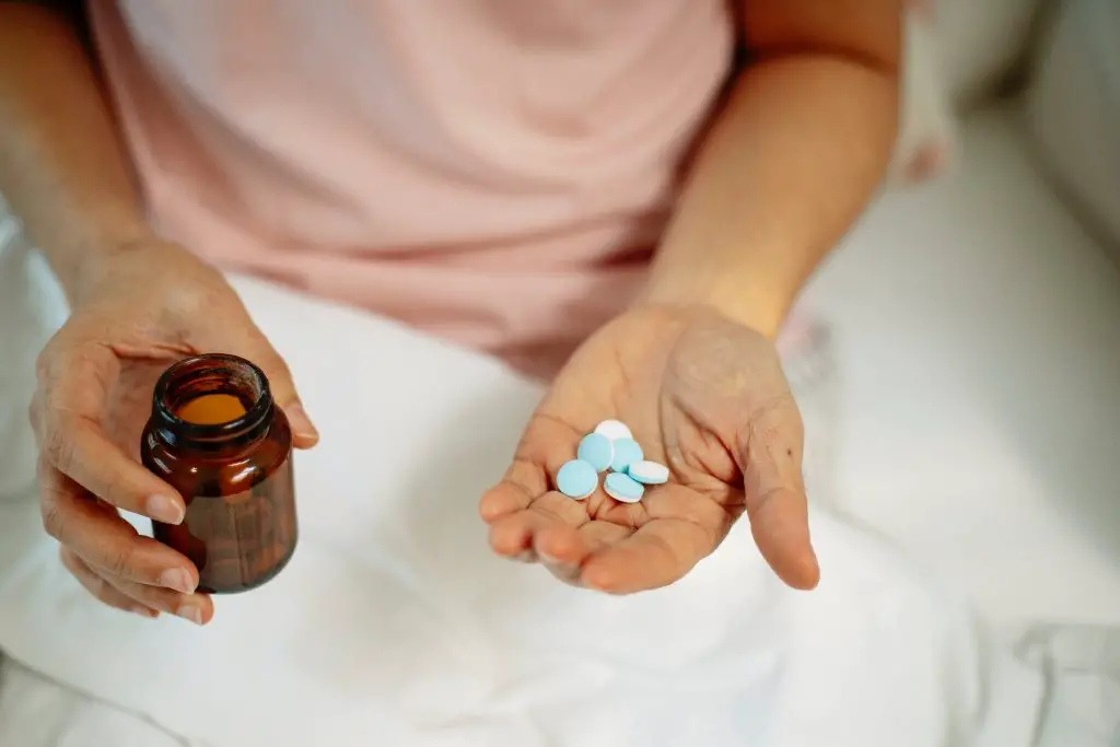 Woman holding vitamins